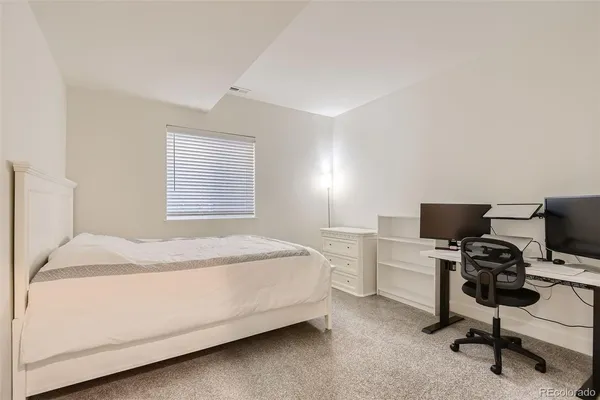 a bedroom with a bed and a chair