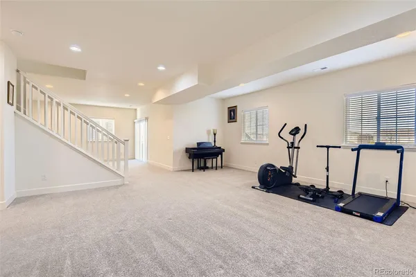 a room with gym equipment and a large window