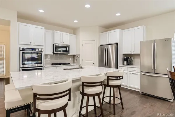 a kitchen with stainless steel appliances a refrigerator stove microwave and cabinets