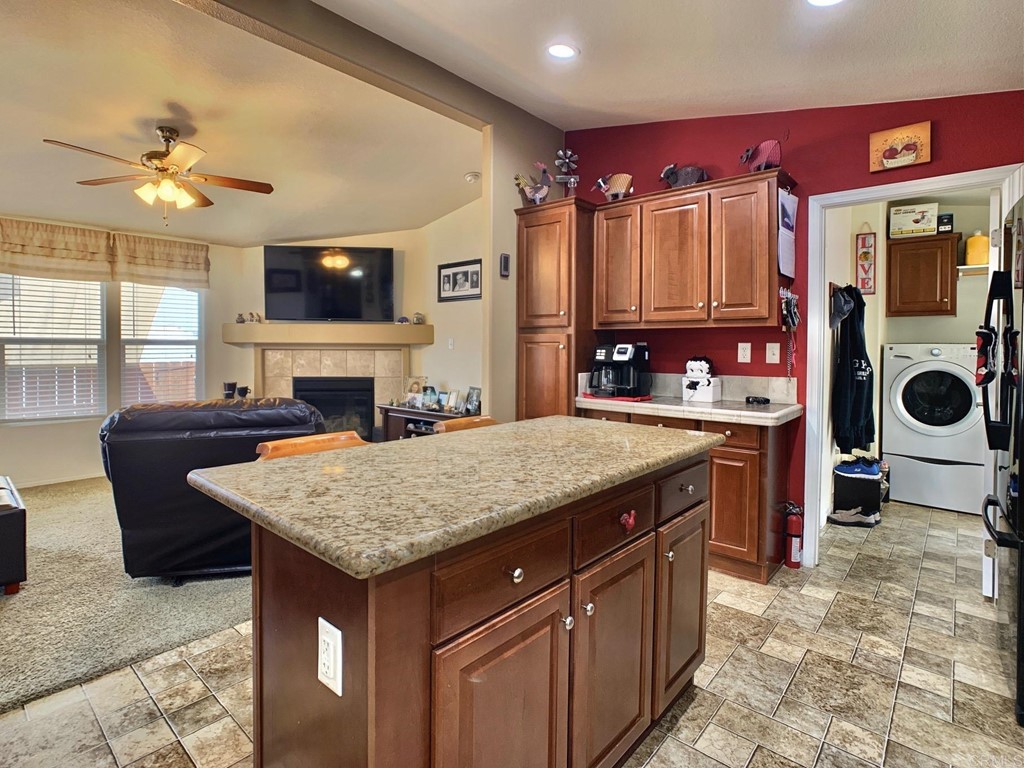 14360 Rios Canyon Road, Unit 20 El Cajon, CA 92021 - Photo 1 of 1 a kitchen with a stove a counter space a sink and cabinets