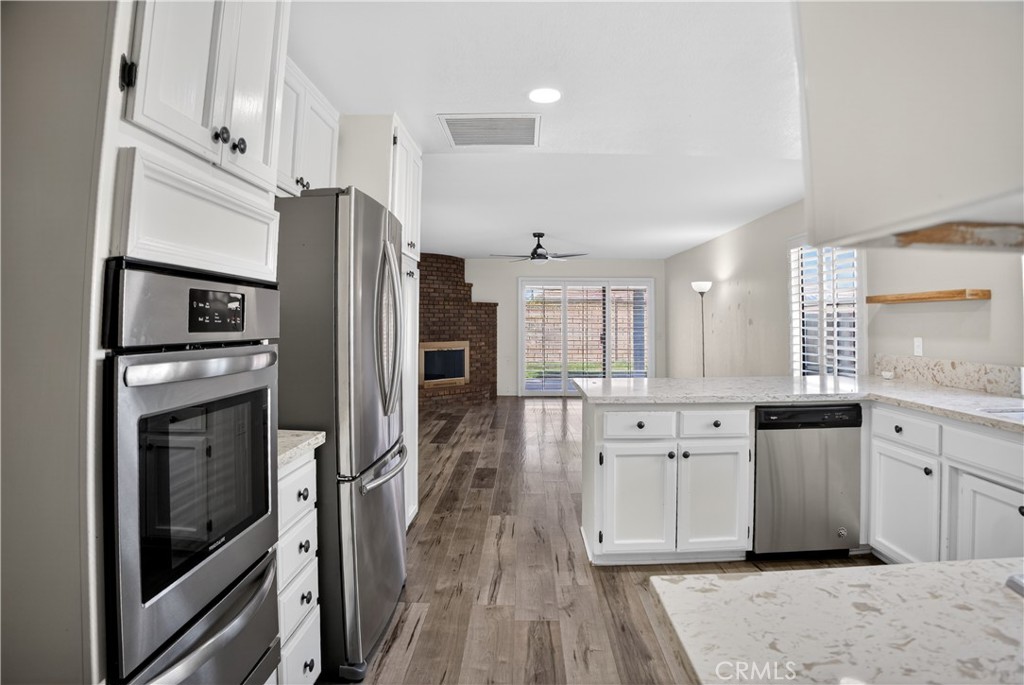 43631 37th Street West Lancaster, CA 93536 - Photo 13 of 38 a kitchen with stainless steel appliances a refrigerator sink and stove