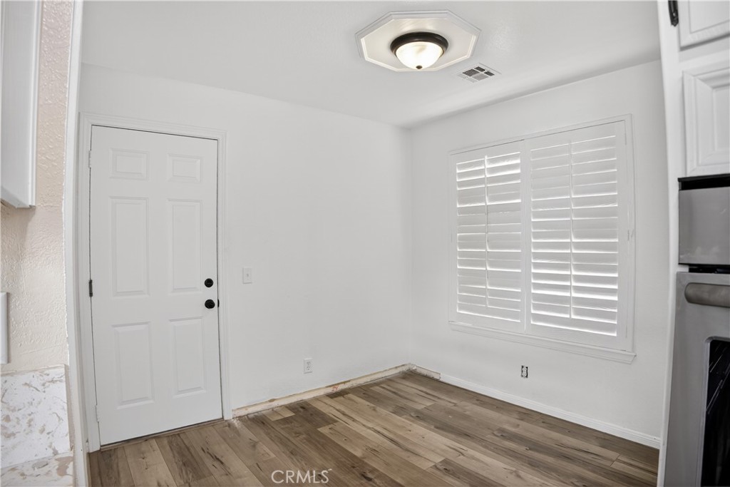 43631 37th Street West Lancaster, CA 93536 - Photo 15 of 38 a view of an empty room with wooden floor and a window