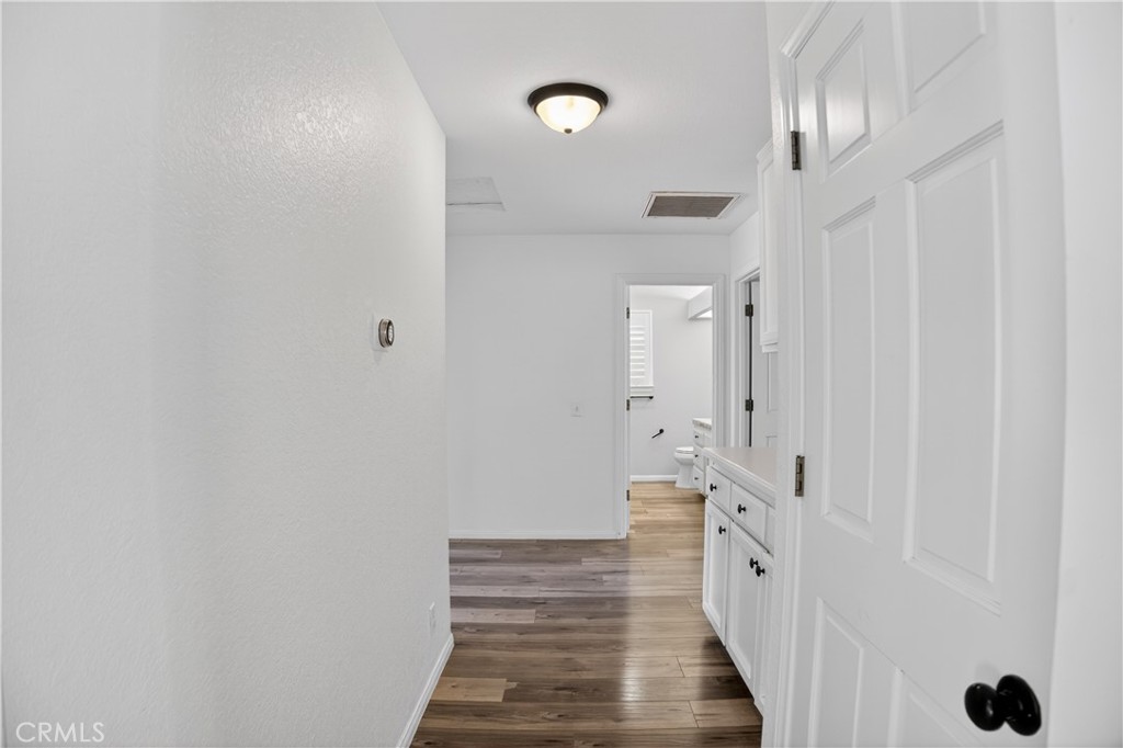 43631 37th Street West Lancaster, CA 93536 - Photo 17 of 38 a view of a hallway with wooden floor and staircase