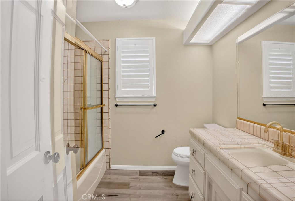 43631 37th Street West Lancaster, CA 93536 - Photo 22 of 38 a bathroom with a granite countertop sink toilet and shower