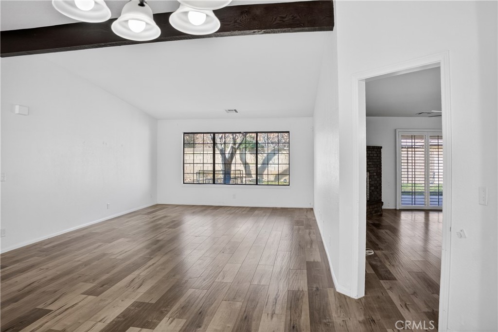 43631 37th Street West Lancaster, CA 93536 - Photo 5 of 38 wooden floor in an empty room with a window