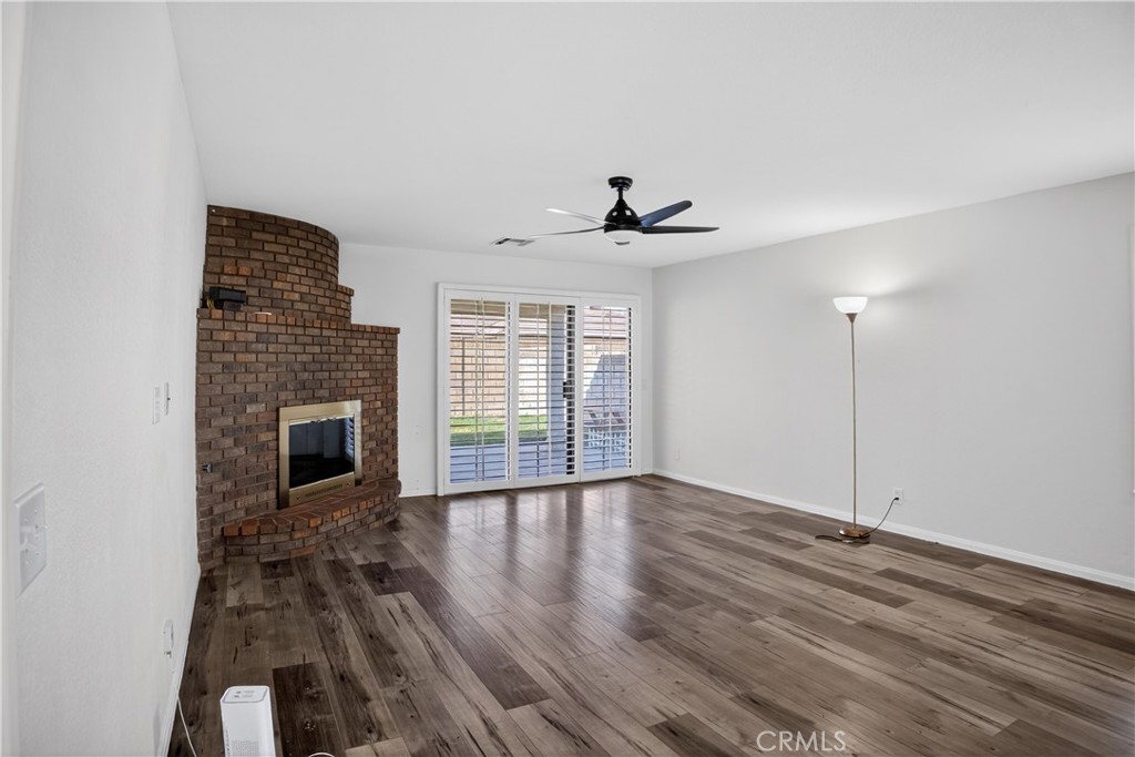 43631 37th Street West Lancaster, CA 93536 - Photo 6 of 38 a view of empty room with wooden floor and fireplace
