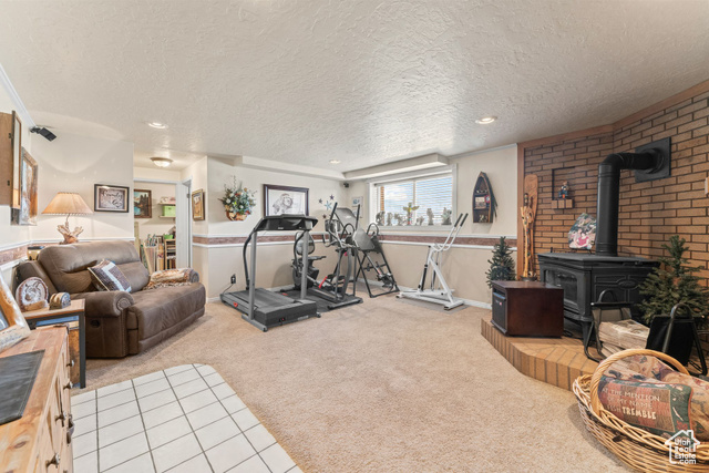 6407 North Dry Frk Cyn Road West Vernal, UT 84078 - Photo 36 of 48 Workout area featuring a wood stove, carpet, a textured ceiling, and recessed lighting