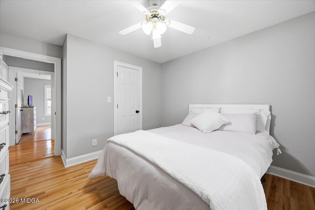 557 Aarons Circle Gray, GA 31032 - Photo 25 of 36 a bedroom with a bed and a chandelier