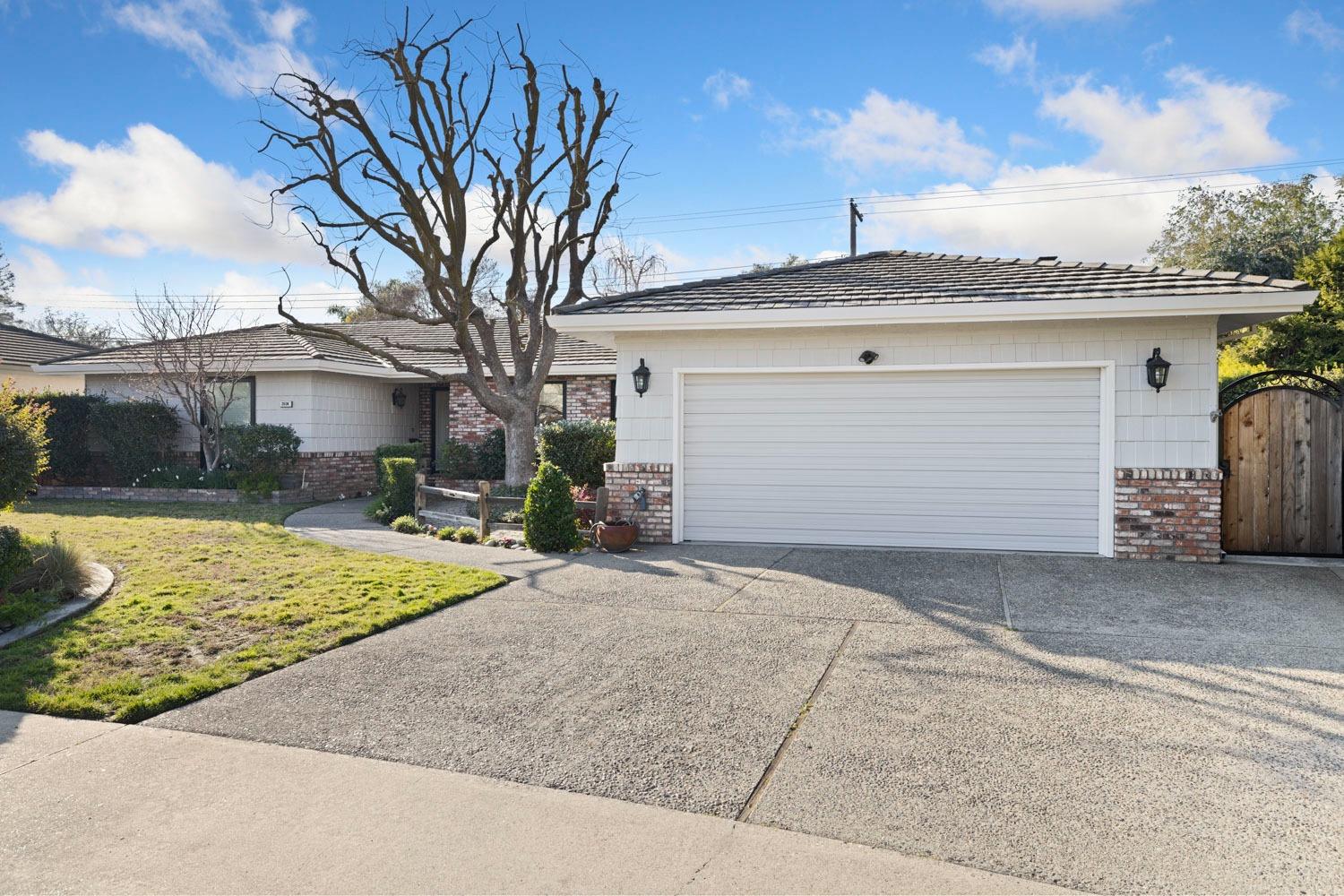 2034 Edgewood Drive Lodi, CA 95242 - Photo 1 of 1 a front view of a house with a yard and garage