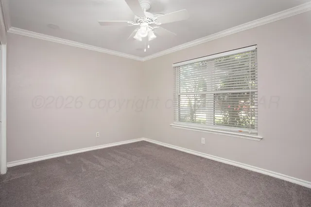 an empty room with a window and a fan