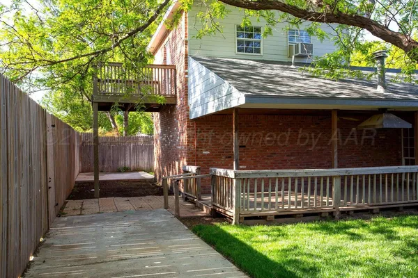 a view of a house with a backyard and deck