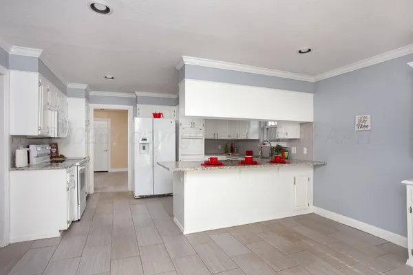 a kitchen with stainless steel appliances a sink and a refrigerator