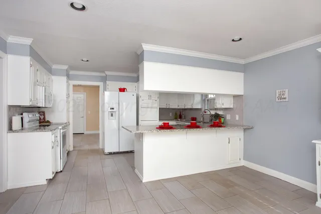 a kitchen with stainless steel appliances a sink and a refrigerator
