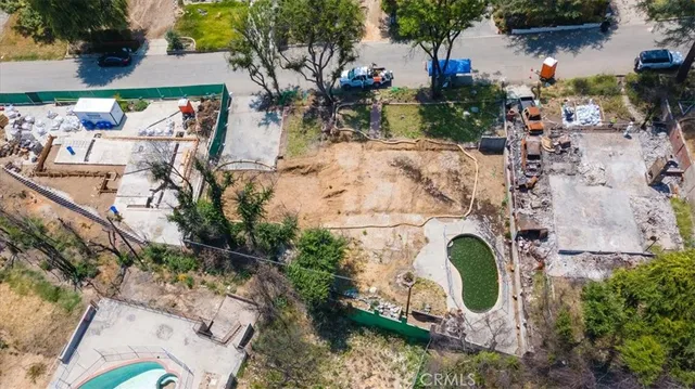 an aerial view of a house with a yard and a fire pit