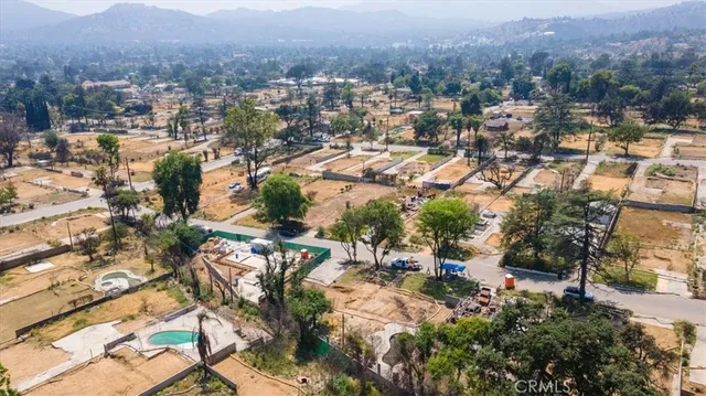 an aerial view of residential house with green space