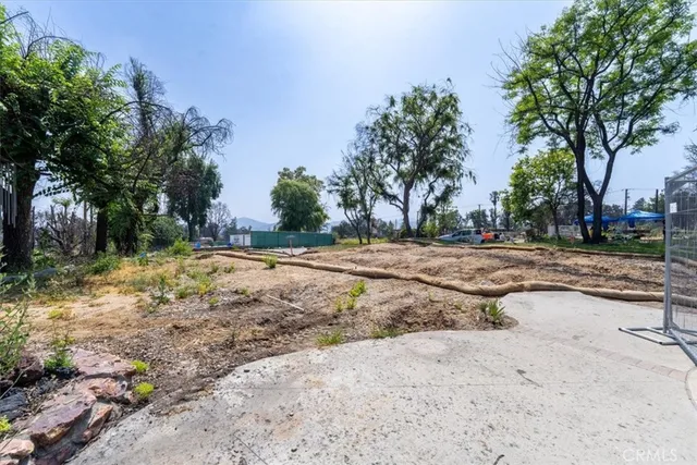 a view of dirt yard with a trees