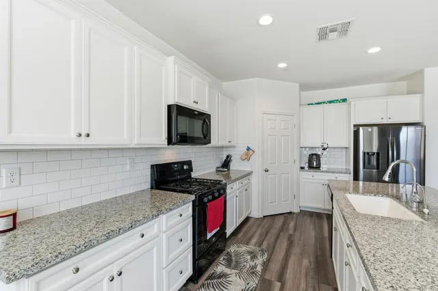 a living room with granite countertop couches a coffee table and a fireplace