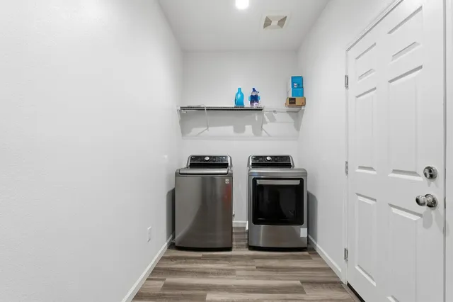 a view of a hallway with a room and a bathroom