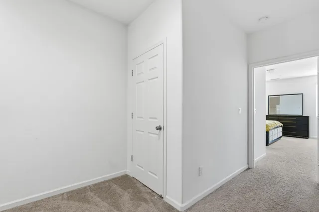 a spacious bedroom with a bed and a table in it