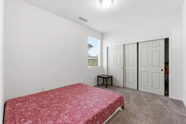 a bedroom with a bed and window