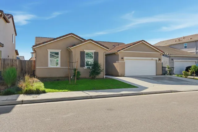 an aerial view of a house with yard