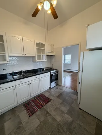 a kitchen with stainless steel appliances a stove a refrigerator and cabinets