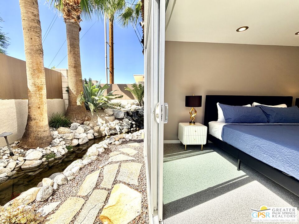 588 East San Lorenzo Road, Unit 104 Palm Springs, CA 92264 - Photo 24 of 74 a bedroom with a bed and a couch