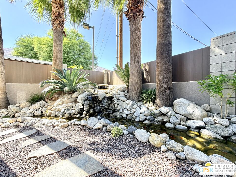 588 East San Lorenzo Road, Unit 104 Palm Springs, CA 92264 - Photo 41 of 74 a bunch of flowers in a yard