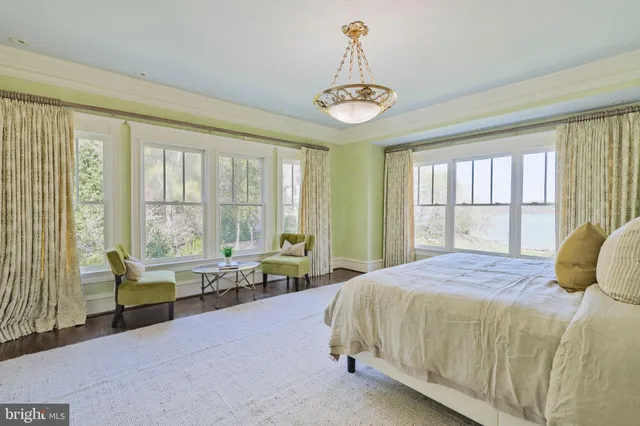 a bedroom with a bed and a large window