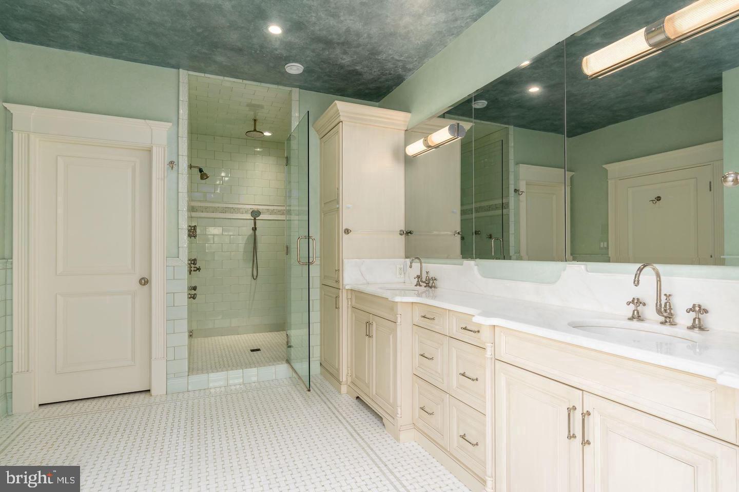 833 Herbert Springs Road Alexandria, VA 22308 - Photo 21 of 34 a spacious bathroom with a shower sink double and mirror