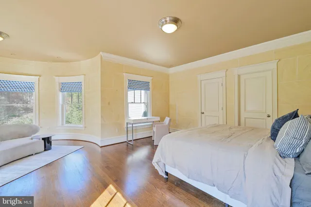 a spacious bedroom with a bed and a large window