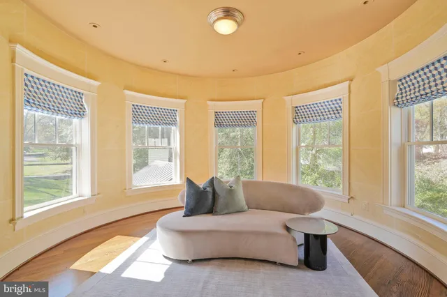 a living room with furniture and floor to ceiling windows
