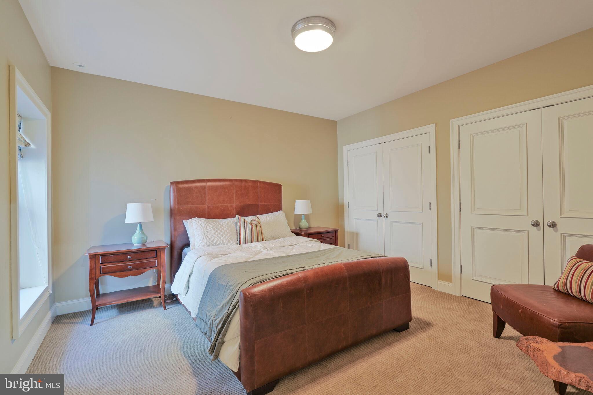 833 Herbert Springs Road Alexandria, VA 22308 - Photo 30 of 34 a bedroom with a bed and a chair