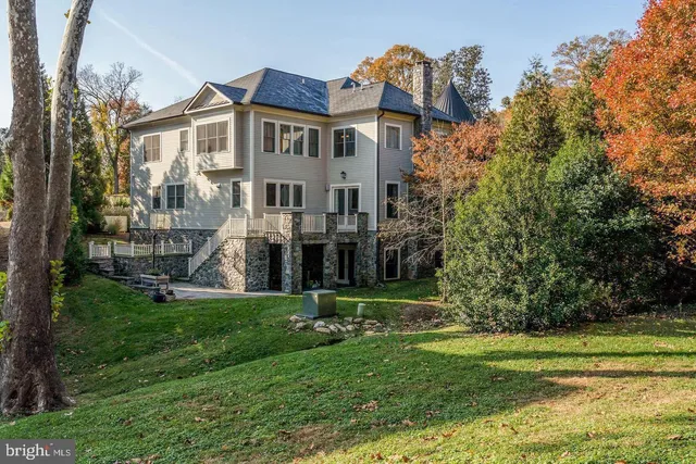 a view of a house with a big yard and potted plants