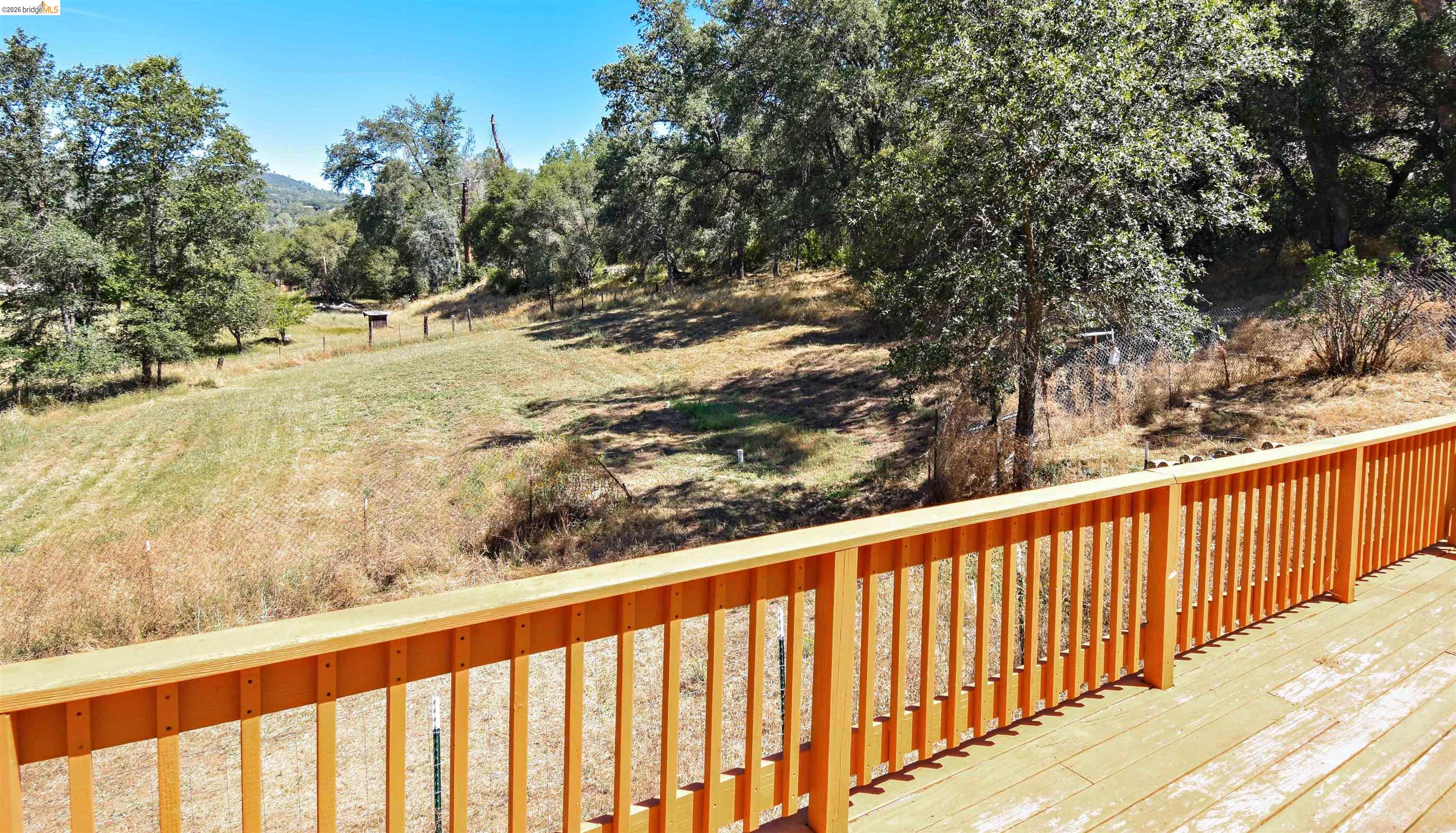 13904 Tuolumne Road Sonora, CA 95370 - Photo 30 of 44 Expansive outdoor deck featuring wood-finish decking and a matching wood railing