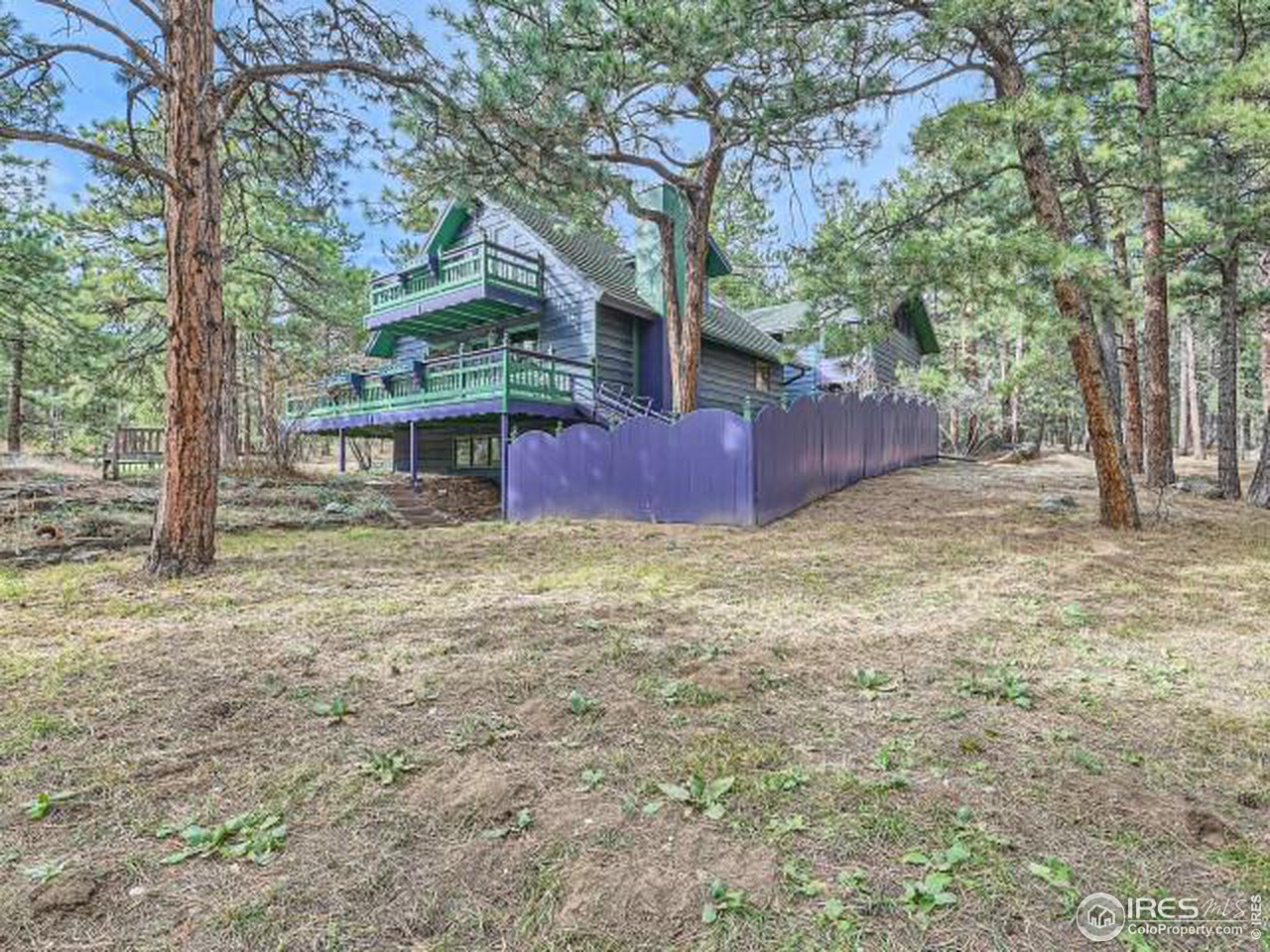 28 Wild Tiger Road Boulder, CO 80302 - Photo 28 of 39 a view of a backyard with large trees and wooden fence