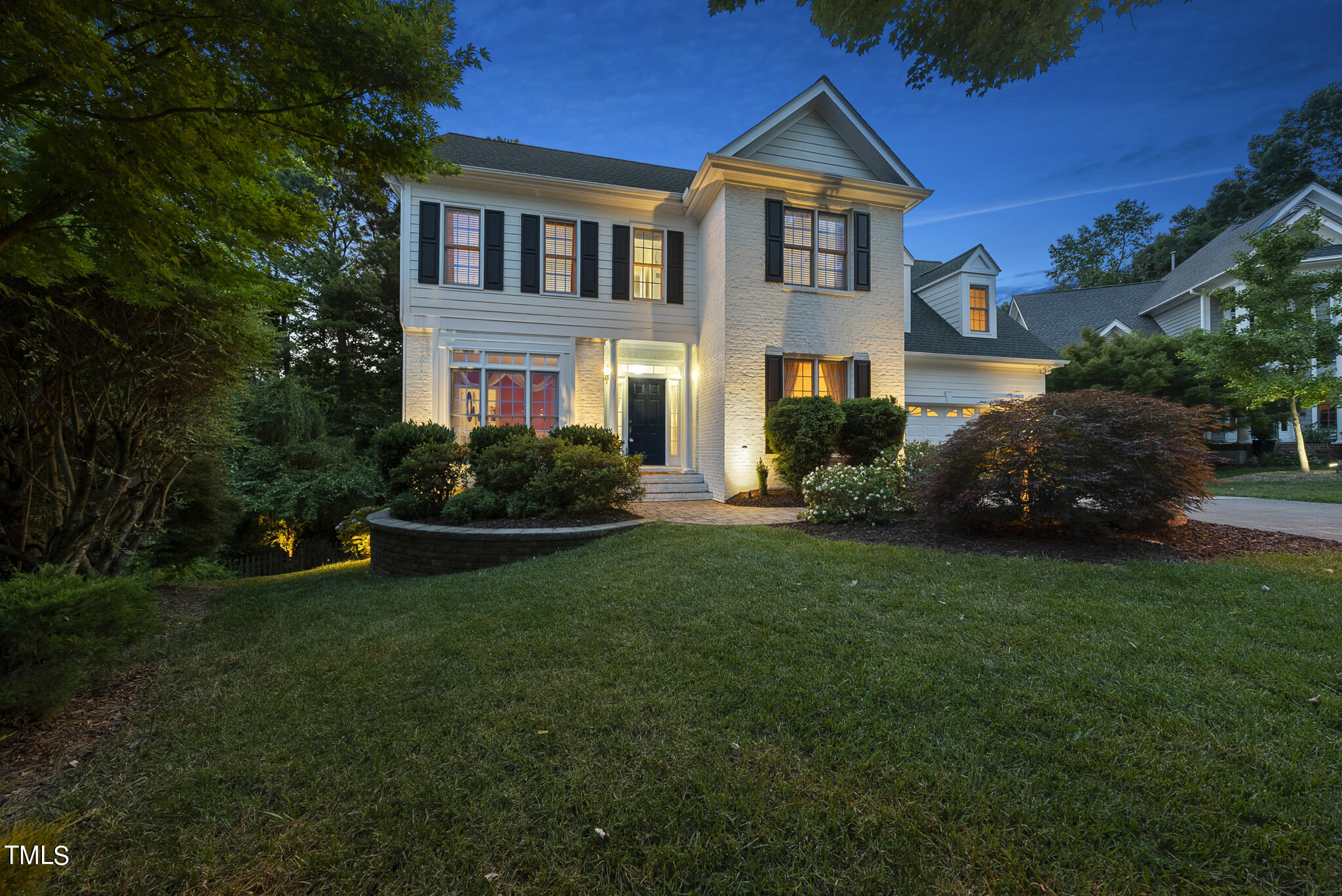 a front view of house with yard and green space