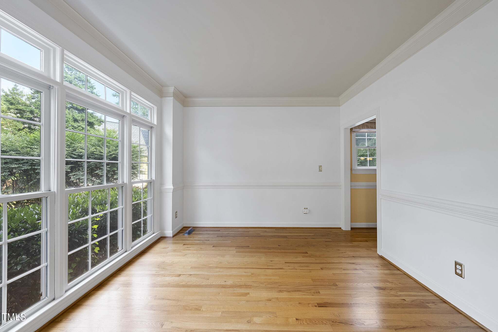 5509 Killarney Hope Drive Raleigh, NC 27613 - Photo 22 of 77 a view of empty room with wooden floor and fan