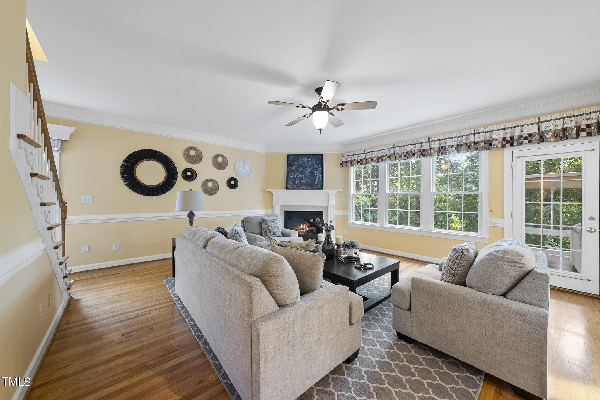 5509 Killarney Hope Drive Raleigh, NC 27613 - Photo 24 of 77 a living room with furniture a fireplace and a large window