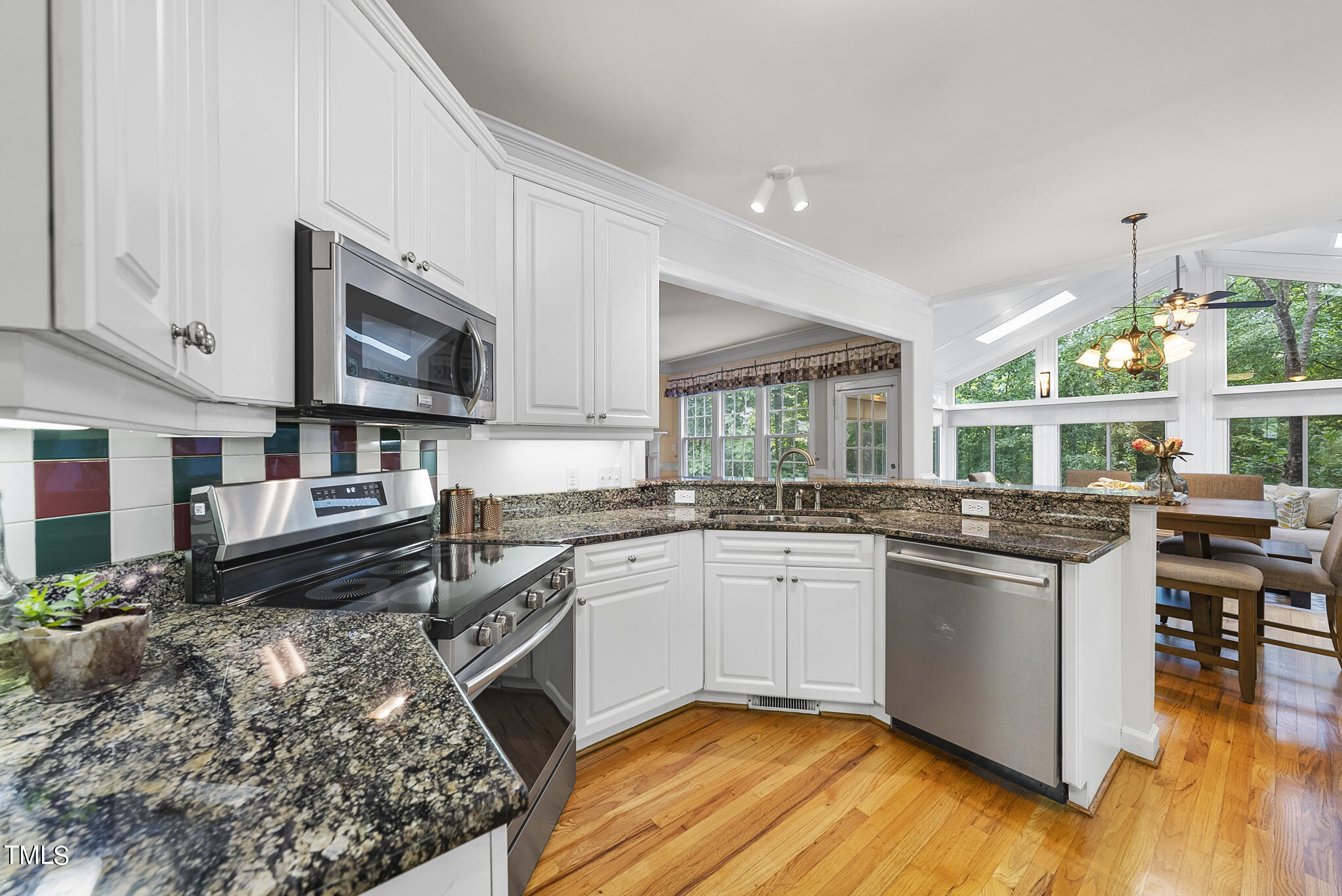 5509 Killarney Hope Drive Raleigh, NC 27613 - Photo 26 of 77 a kitchen with stainless steel appliances granite countertop a stove and a sink