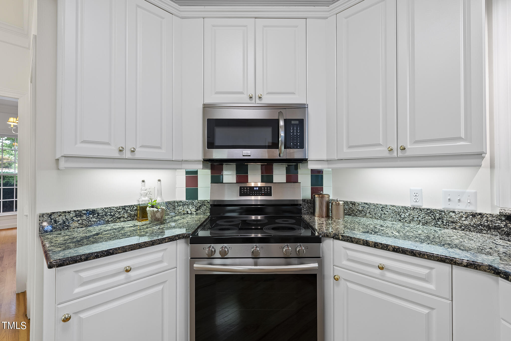5509 Killarney Hope Drive Raleigh, NC 27613 - Photo 27 of 77 a kitchen with granite countertop white cabinets and stainless steel appliances