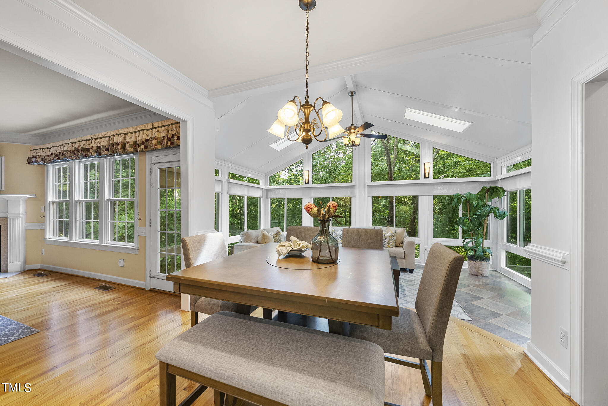 5509 Killarney Hope Drive Raleigh, NC 27613 - Photo 38 of 77 a dining room with furniture a large window and a chandelier
