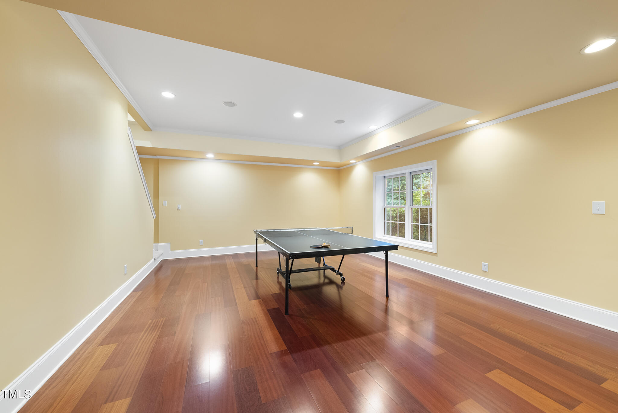 5509 Killarney Hope Drive Raleigh, NC 27613 - Photo 41 of 77 a view of an empty room with wooden floor and a window