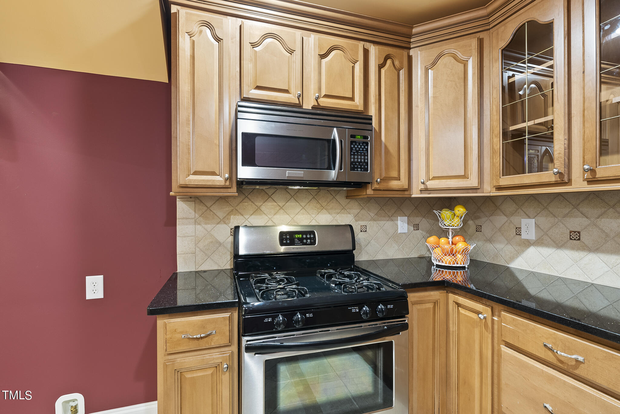 5509 Killarney Hope Drive Raleigh, NC 27613 - Photo 44 of 77 a kitchen with stainless steel appliances granite countertop a stove top oven microwave and cabinets
