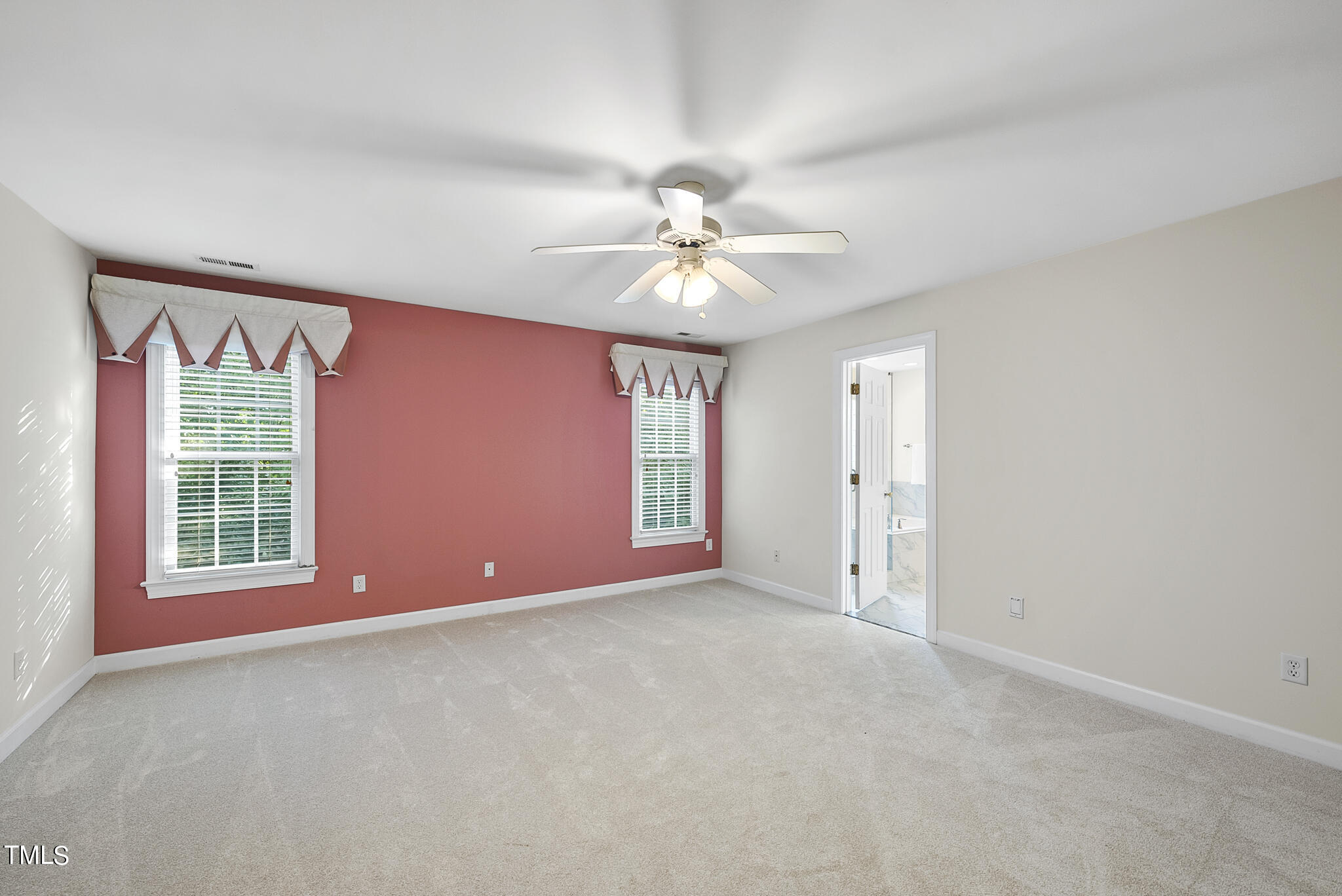 5509 Killarney Hope Drive Raleigh, NC 27613 - Photo 53 of 77 an empty room with windows and chandelier fan