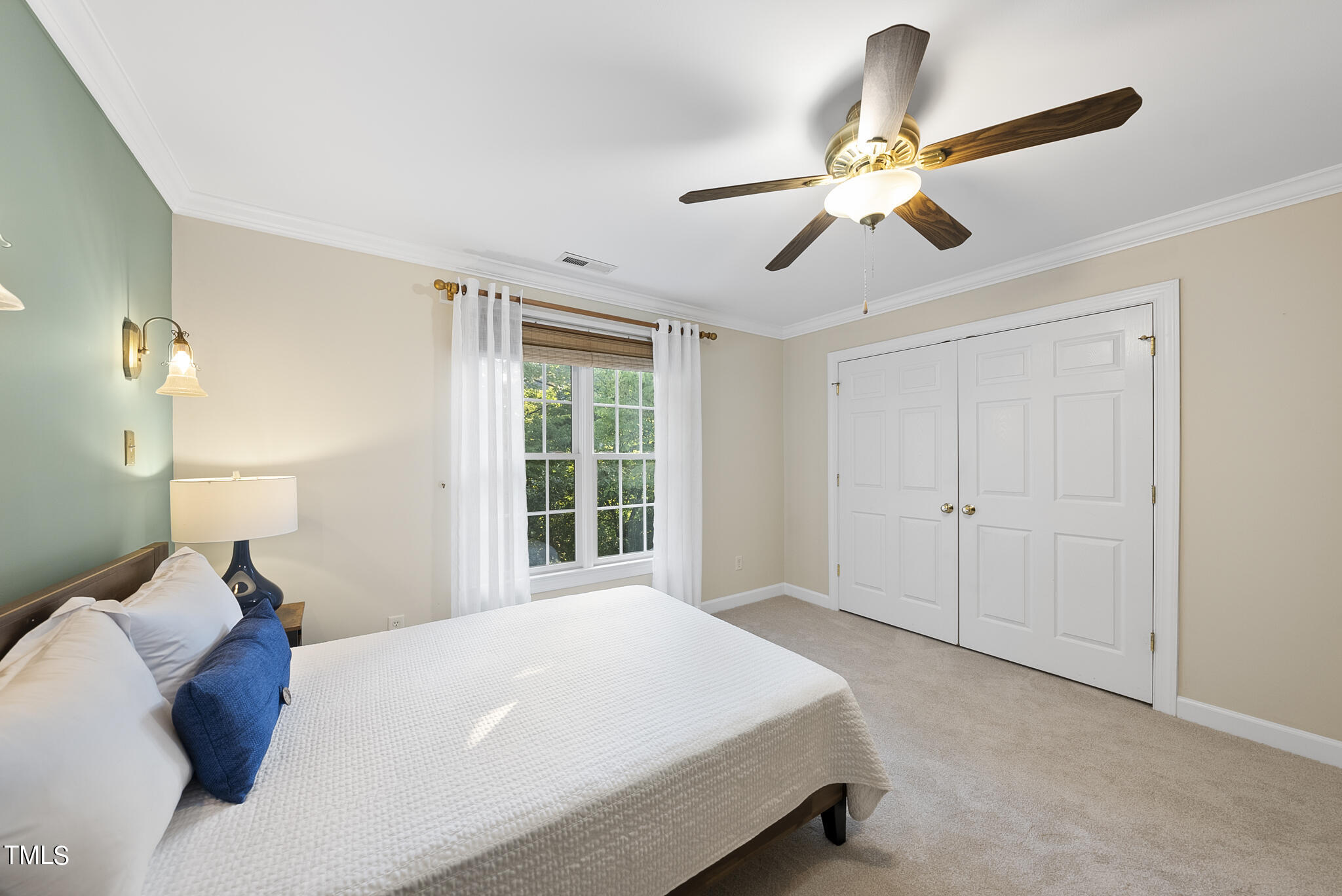 5509 Killarney Hope Drive Raleigh, NC 27613 - Photo 62 of 77 a bedroom with a bed and a chandelier