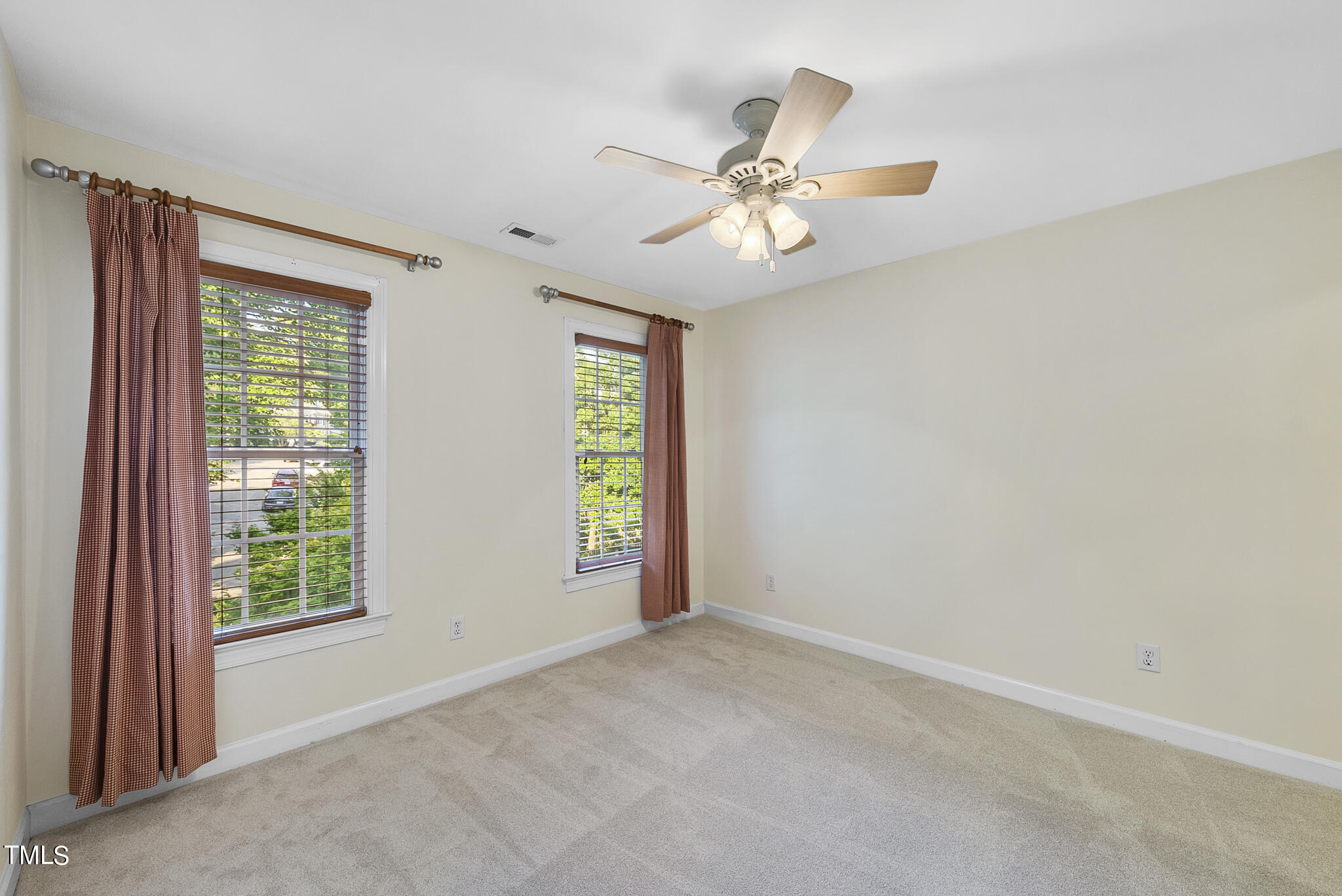 5509 Killarney Hope Drive Raleigh, NC 27613 - Photo 69 of 77 an empty room with windows and fan