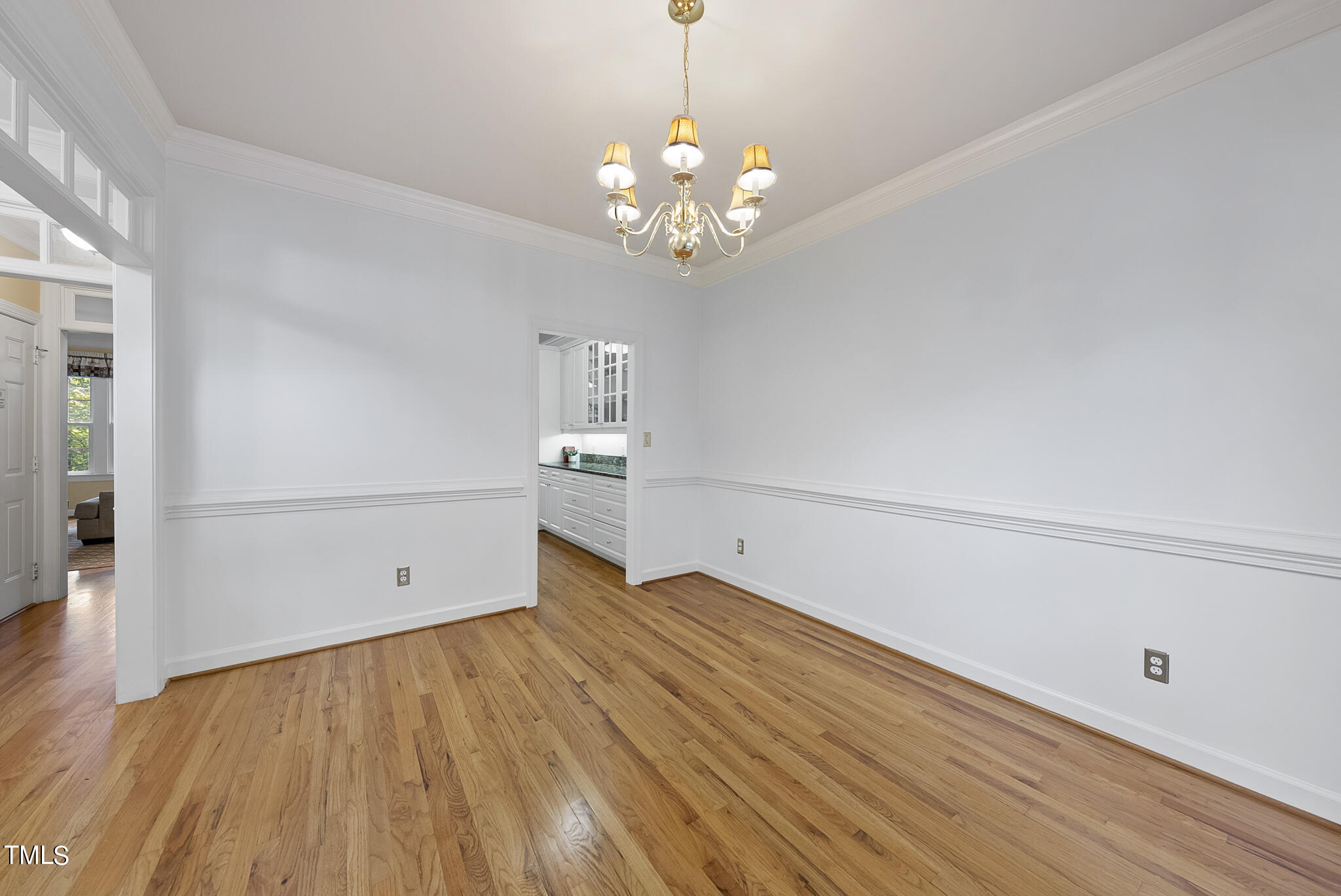 5509 Killarney Hope Drive Raleigh, NC 27613 - Photo 8 of 77 a view of an empty room with wooden floor and a window