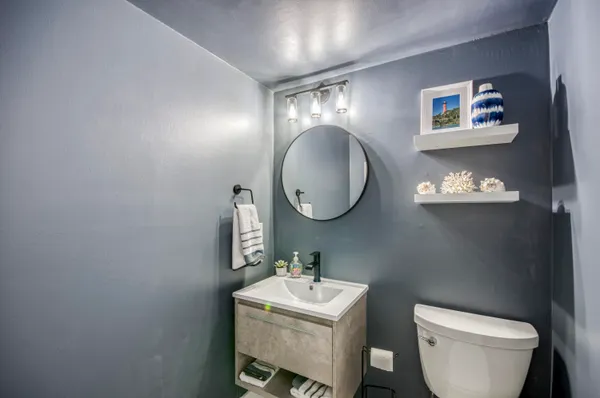 a bathroom with a toilet a sink and a mirror