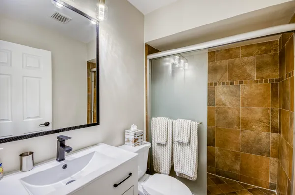 a bathroom with a sink toilet and shower